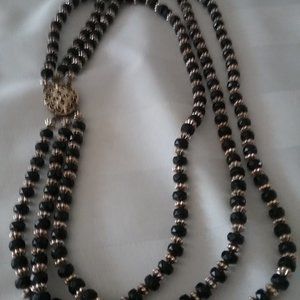This a stunning old Necklace Black & Gold the Clasp tells the story